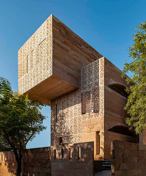 hollow stone walls wrap climate-responsive residence by malik architecture in india