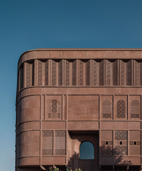 hand-carved red sandstone clads jewelry store's facade by studio lotus in jaipur