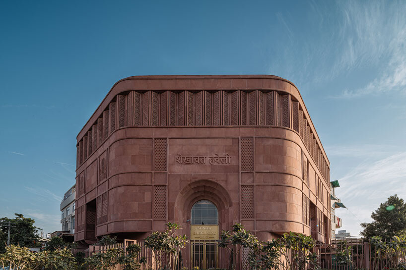 hand-carved red sandstone clads jewelry store's facade by studio lotus in jaipur