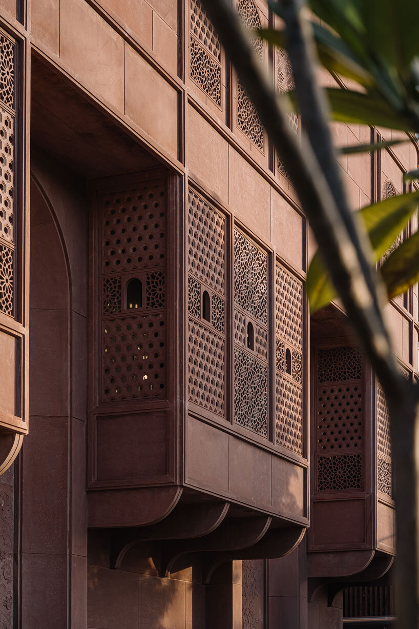 hand-carved red sandstone clads jewelry store's facade by studio lotus in jaipur