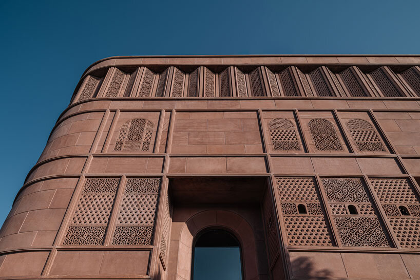 hand-carved red sandstone clads jewelry store's facade by studio lotus in jaipur