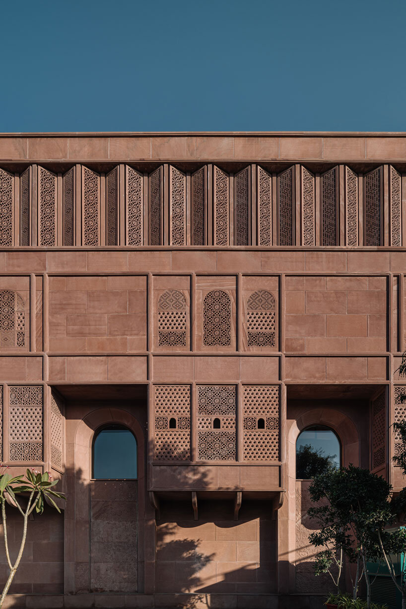 hand-carved red sandstone clads jewelry store's facade by studio lotus in jaipur