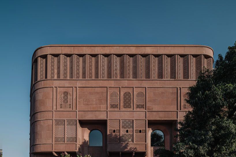 hand-carved red sandstone clads jewelry store's facade by studio lotus in jaipur