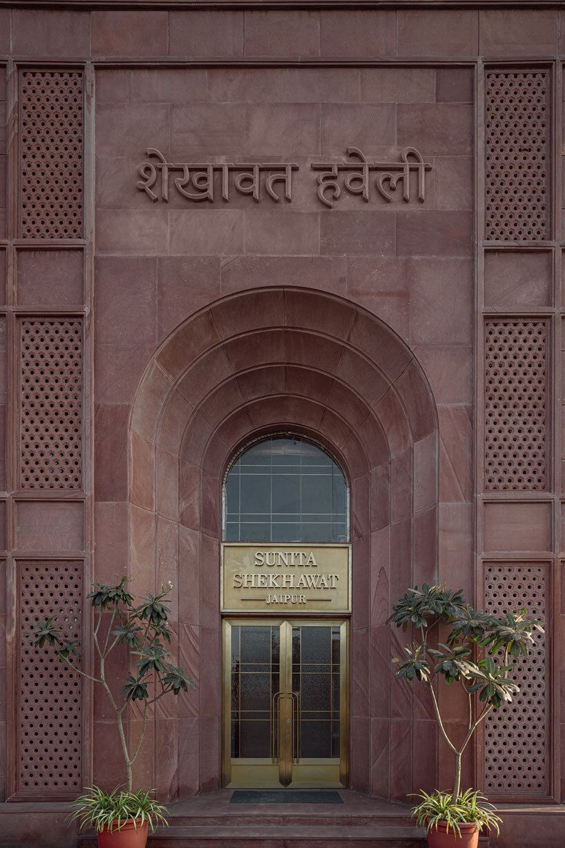 hand-carved red sandstone clads jewelry store's facade by studio lotus in jaipur