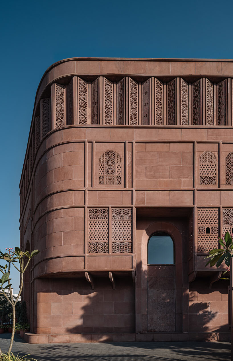 hand-carved red sandstone clads jewelry store's facade by studio lotus in jaipur