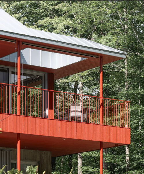 scarlet-red wood clads house by _naturehumaine floating above three streams in canada