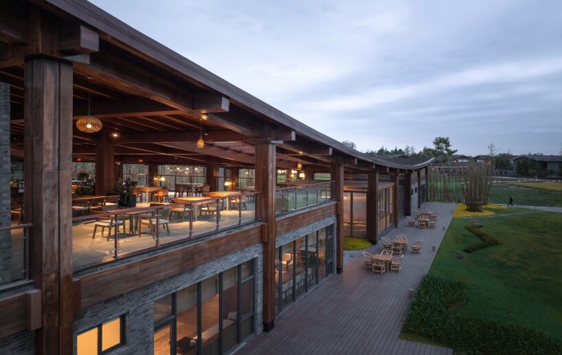 homme architects' round opening above tourist center frames bamboo garden in china fields