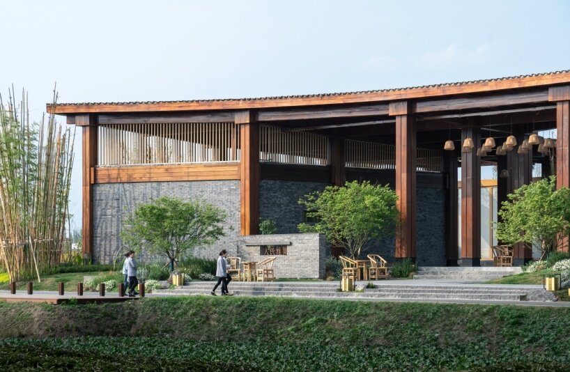 homme architects' round opening above tourist center frames bamboo garden in china fields
