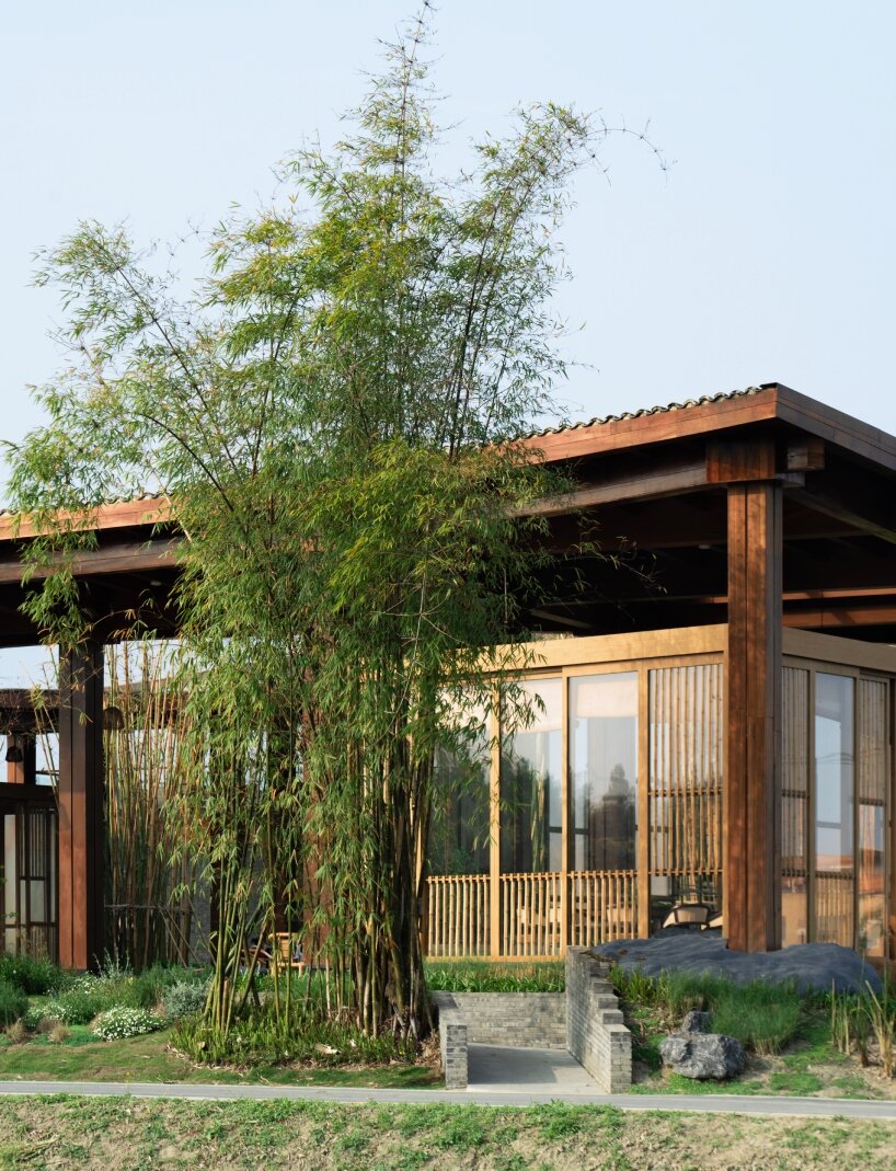homme architects' round opening above tourist center frames bamboo garden in china fields