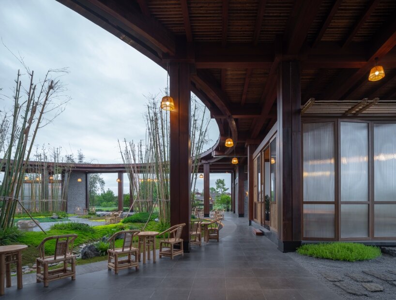 homme architects' round opening above tourist center frames bamboo garden in china fields