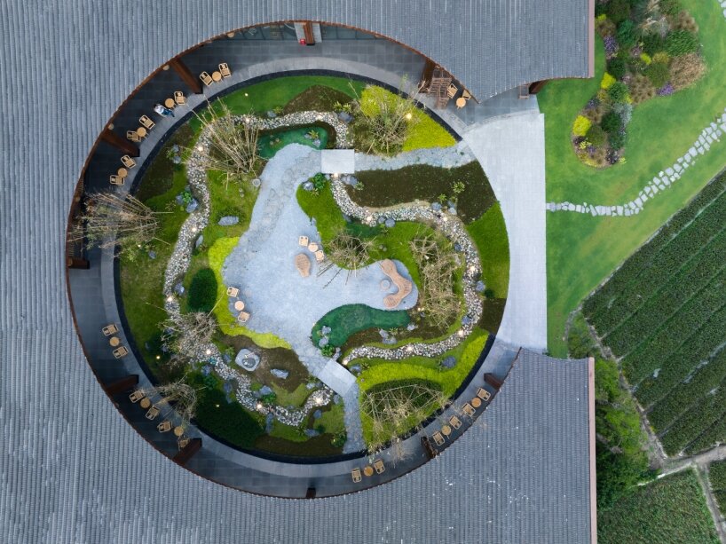 homme architects' round opening above tourist center frames bamboo garden in china fields