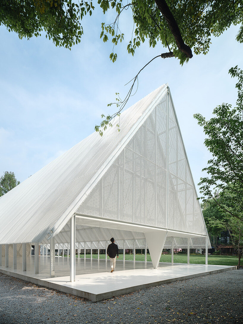 wing-like roof covers open gathering area by SHISUO in shanghai's memorial park