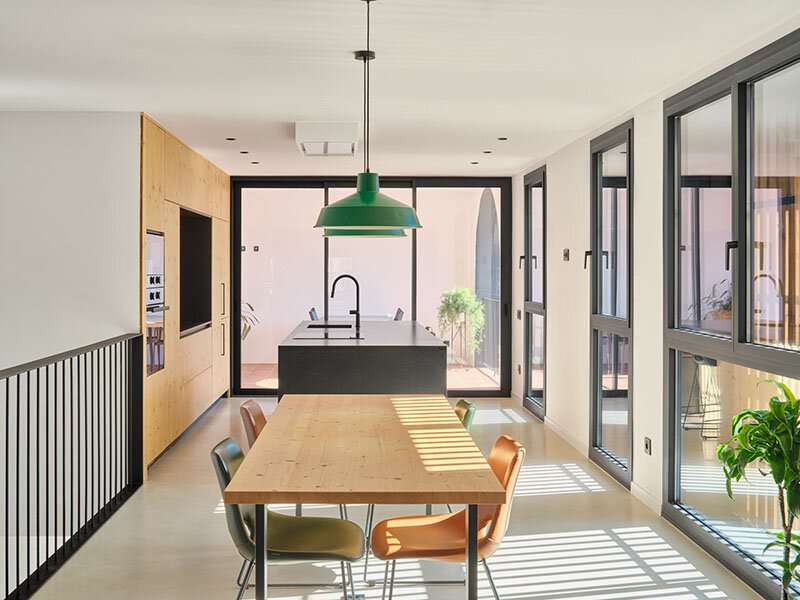 wooden sliding shutters frame arched openings in spanish renovation by sergi pons studio