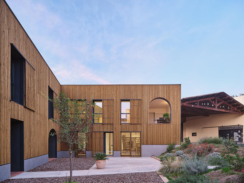 wooden sliding shutters frame arched openings in spanish renovation by sergi pons studio