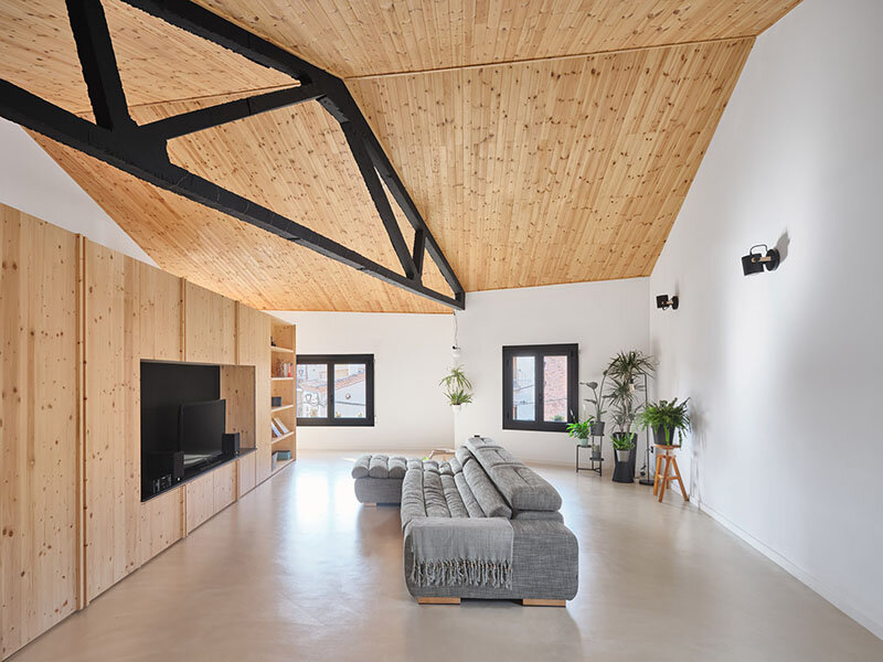 wooden sliding shutters frame arched openings in spanish renovation by sergi pons studio