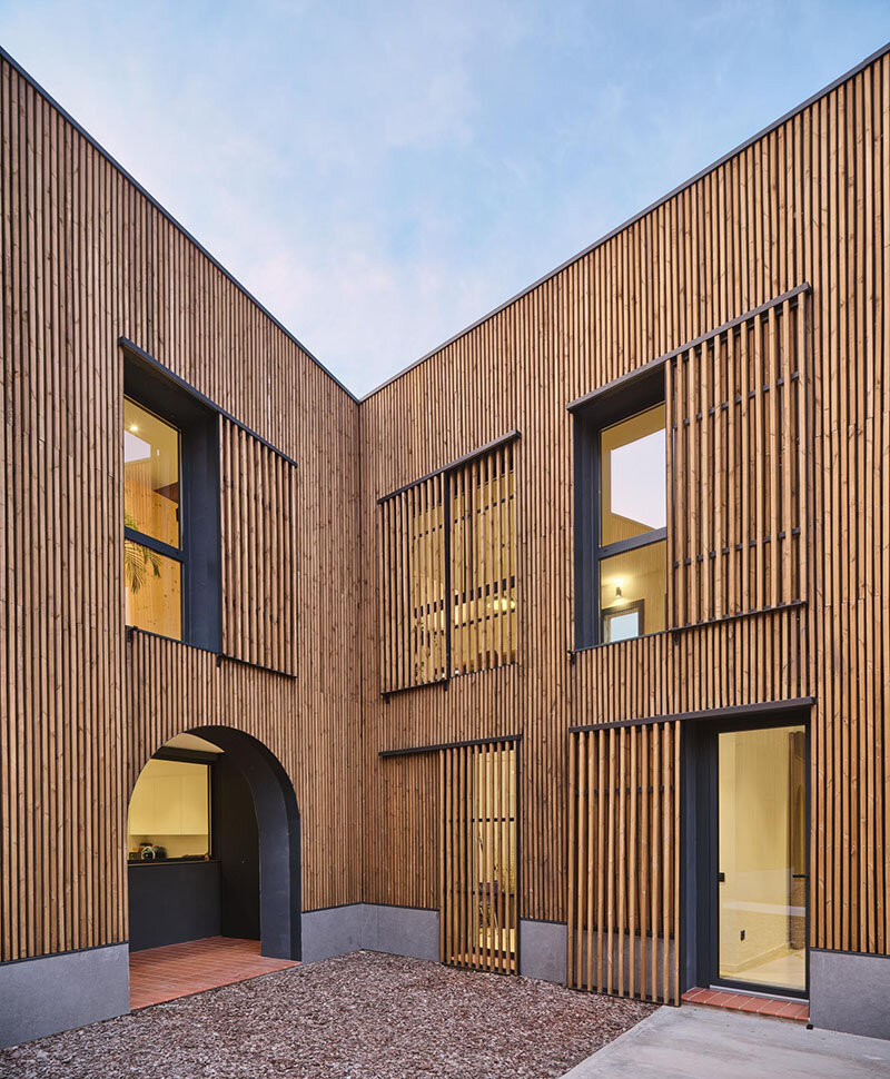 wooden sliding shutters frame arched openings in spanish renovation by sergi pons studio