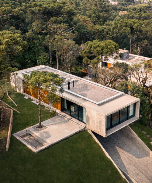 OSPA's concrete altos house cantilevers at a forested brazilian hilltop