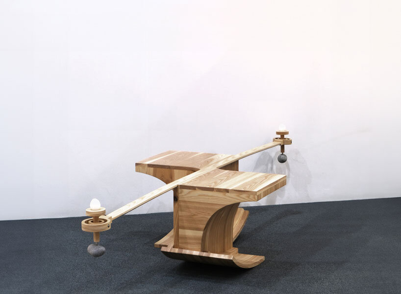 halfway serious wooden chair transforms sitting into a performative act of balance