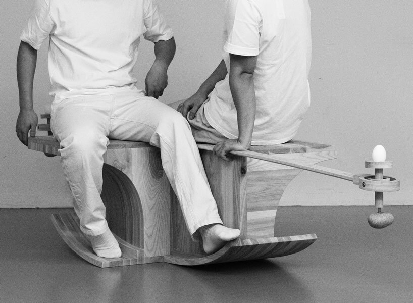 halfway serious wooden chair transforms sitting into a performative act of balance