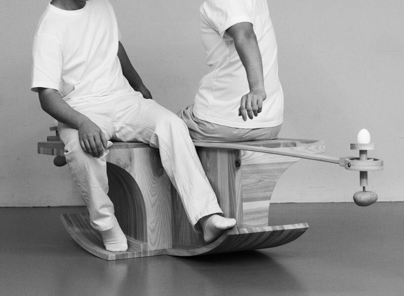 halfway serious wooden chair transforms sitting into a performative act of balance