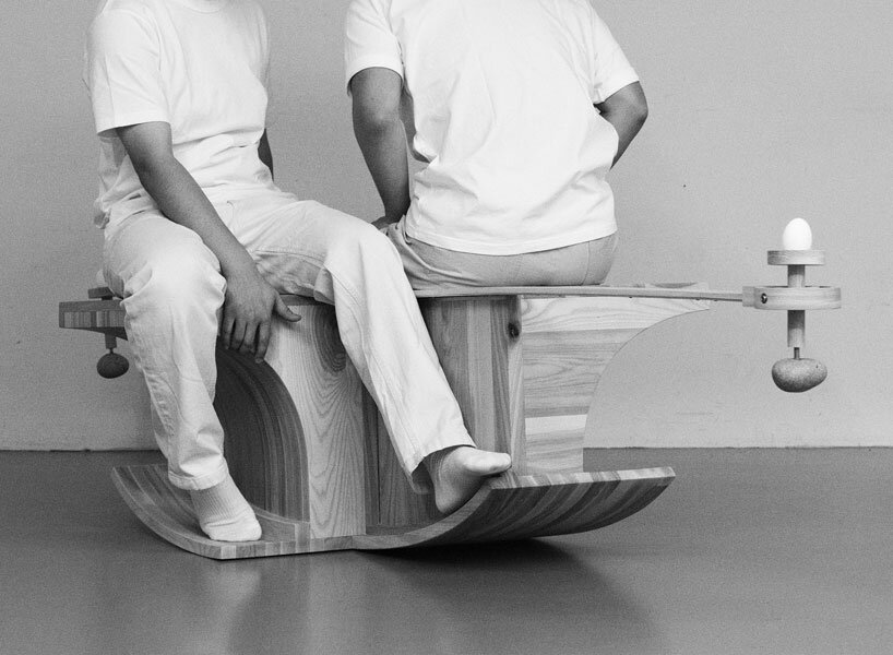 halfway serious wooden chair transforms sitting into a performative act of balance