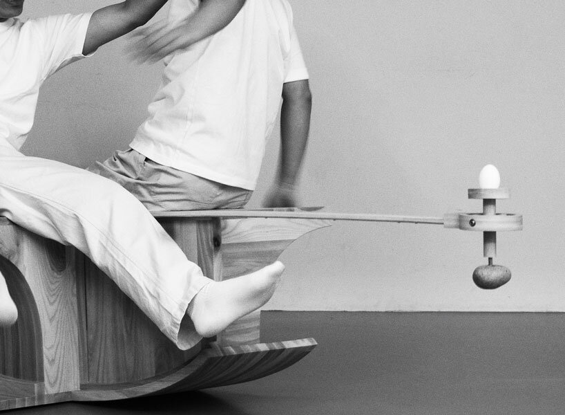 halfway serious wooden chair transforms sitting into a performative act of balance