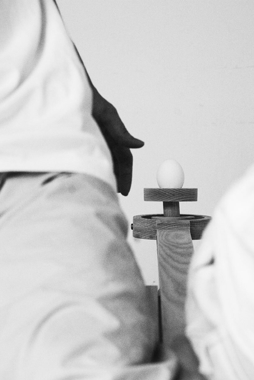 halfway serious wooden chair transforms sitting into a performative act of balance