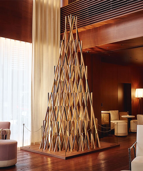 kengo kuma's wooden christmas tree sculptures illuminate EDITION hotels in tokyo