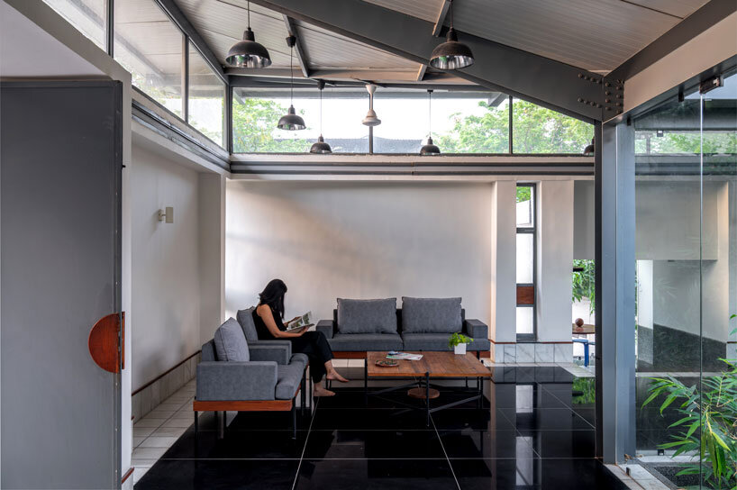 inverted winged hip roof cantilevers over reconstructed office space by compartment S4