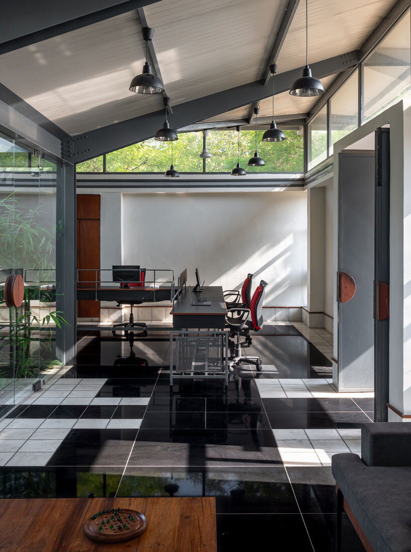 inverted winged hip roof cantilevers over reconstructed office space by compartment S4