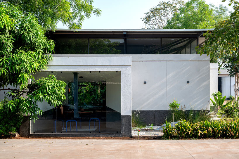 inverted winged hip roof cantilevers over reconstructed office space by compartment S4