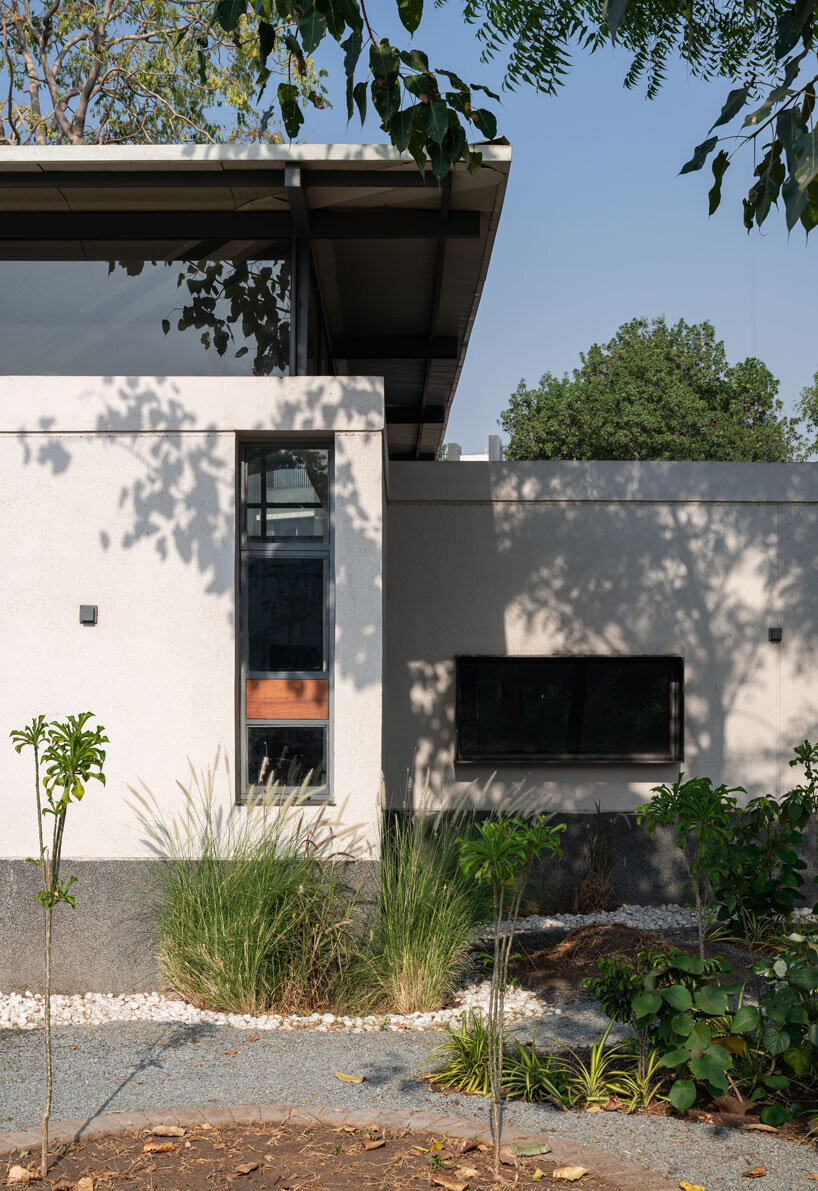 inverted winged hip roof cantilevers over reconstructed office space by compartment S4