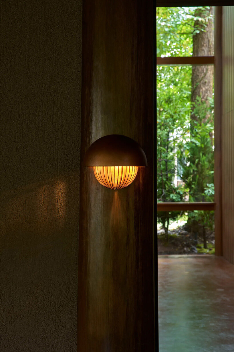 piloti structure suspends villa by and to architects above japan's forest landscape