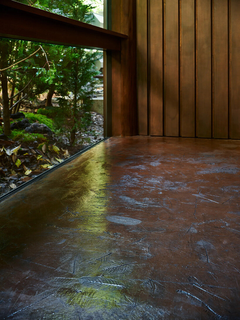 piloti structure suspends villa by and to architects above japan's forest landscape