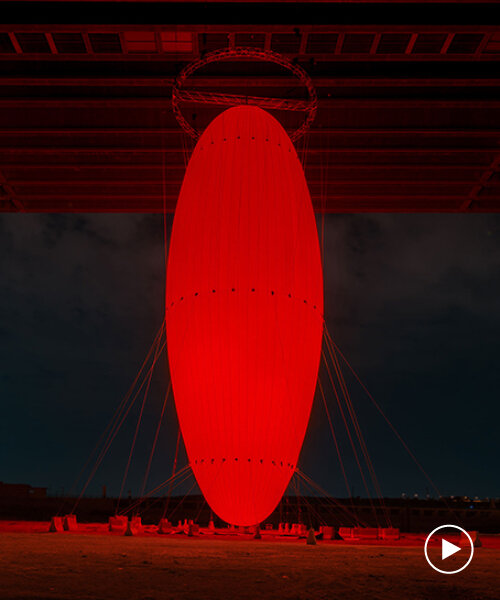 SpY's vast red ovoid suspends from bridge at noor riyadh for glowing gathering point