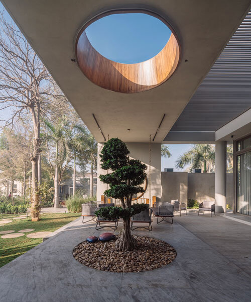 circular wooden apertures puncture through multi-use pavilion by UA lab in india