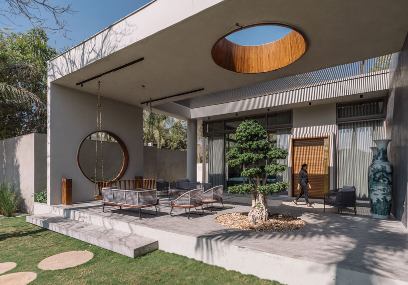 circular wooden apertures puncture through multi-use pavilion by UA lab in india