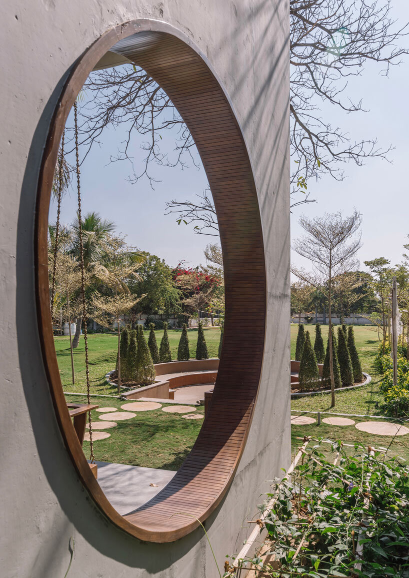 circular wooden apertures puncture through multi-use pavilion by UA lab in india