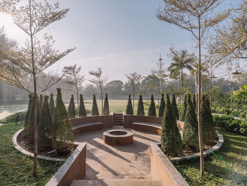 circular wooden apertures puncture through multi-use pavilion by UA lab in india