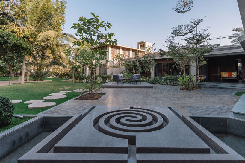 circular wooden apertures puncture through multi-use pavilion by UA lab in india