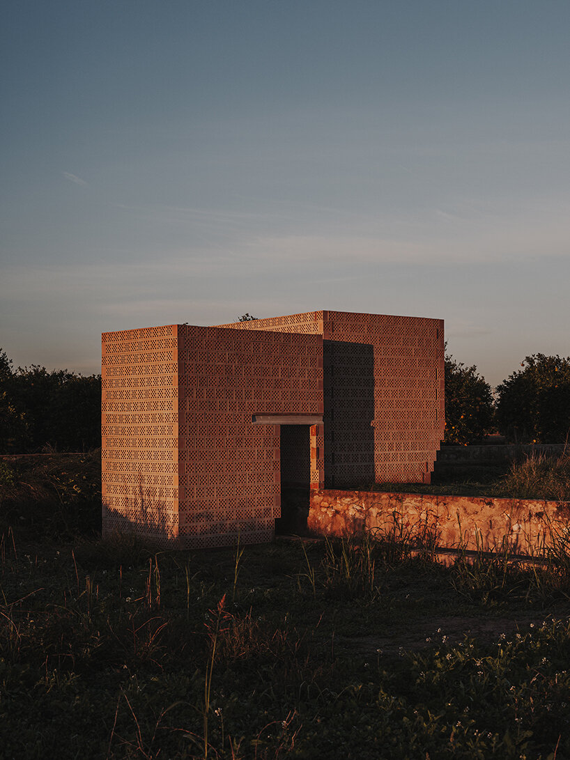 cross-shaped perforations filter light through bona fide taller’s ceramic pavilions in valencia