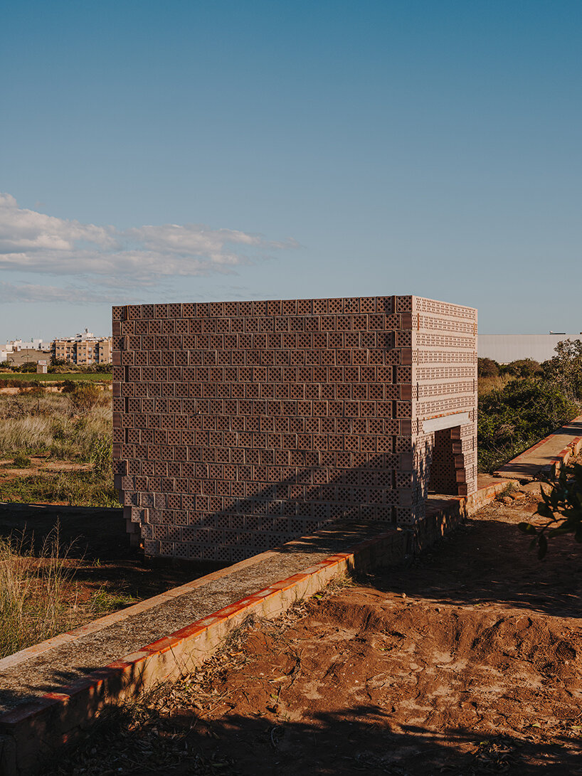 cross-shaped perforations filter light through bona fide taller’s ceramic pavilions in valencia