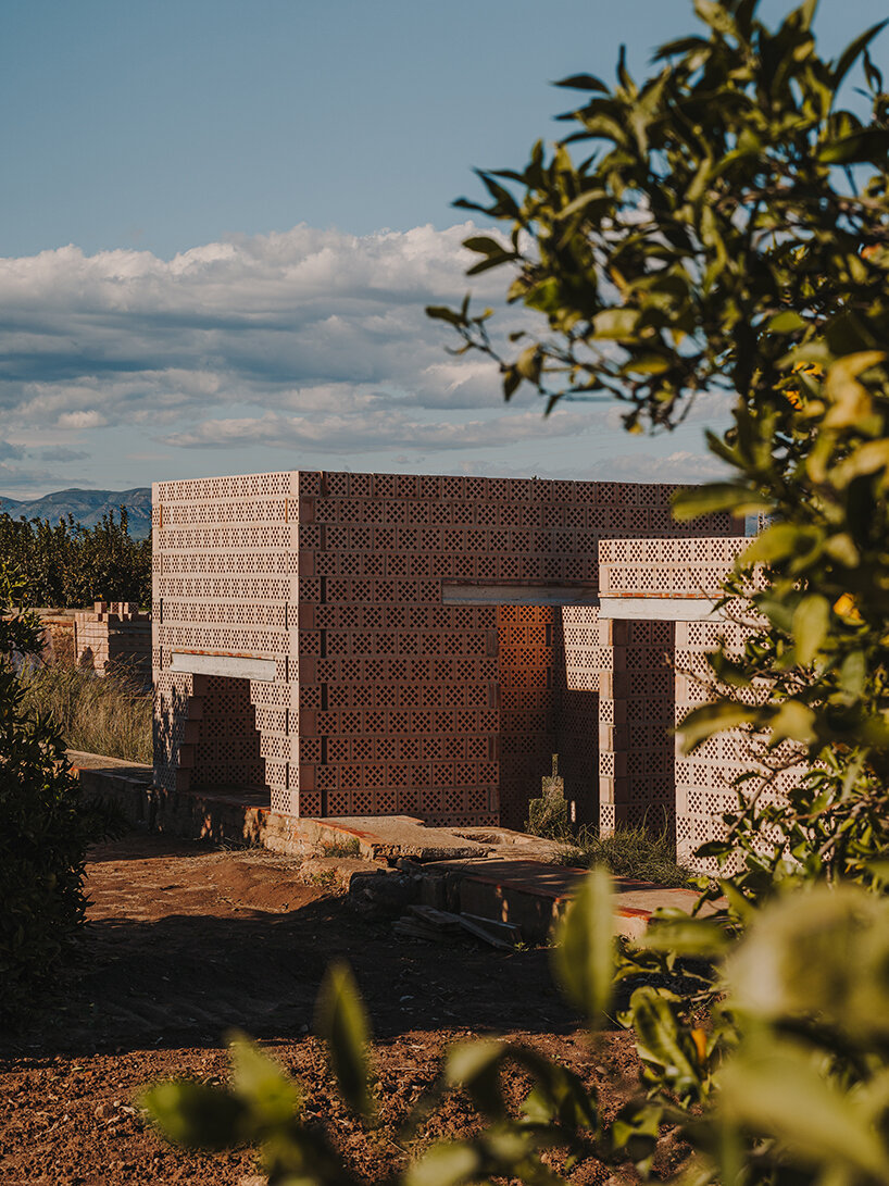 cross-shaped perforations filter light through bona fide taller’s ceramic pavilions in valencia