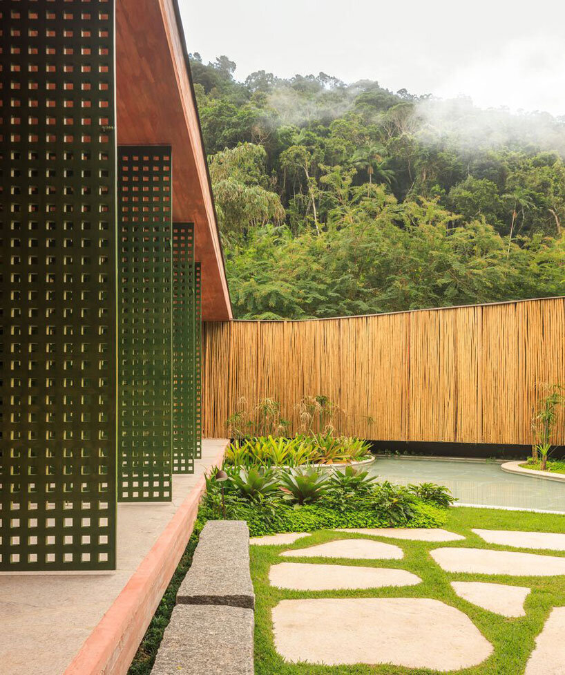 MF+Arquitettos' dry pink concrete residence emerges from Rio de Janeiro's lush jungle