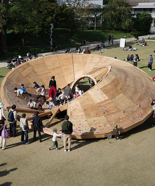 three interlocking timber rings shape TAILAND's playground pavilion in tokyo park