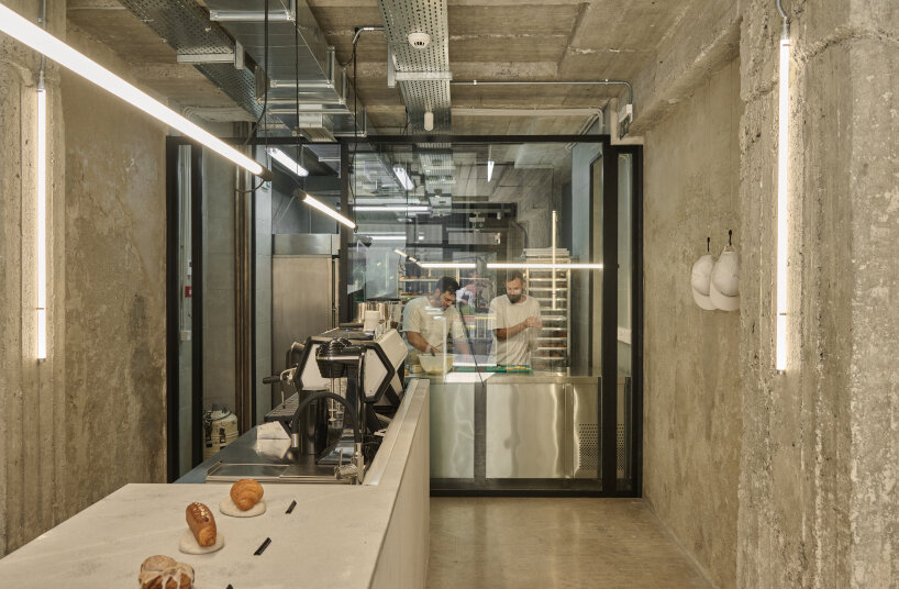 transparent facade reveals bakery's raw industrial interiors by saint of athens