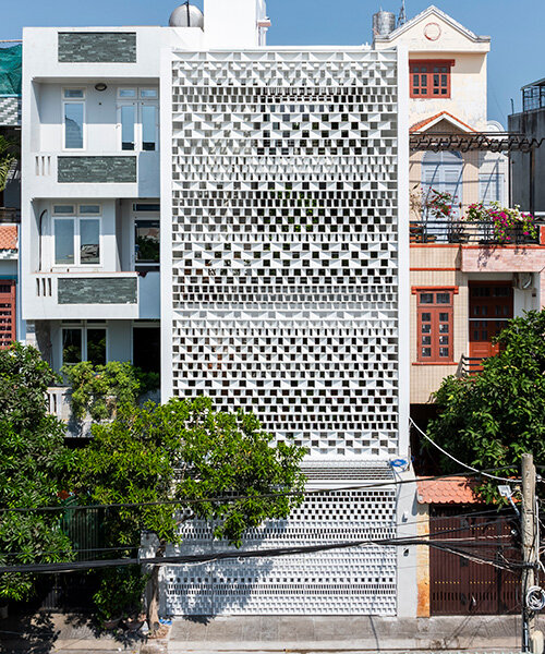 sanuki daisuke architects redefines vietnamese tube house with rhythmic light steel shades