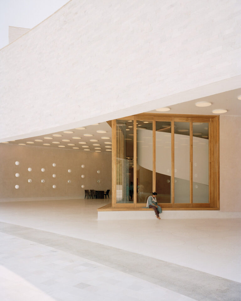 curved white marble volumes shape serie architects' ashram, india