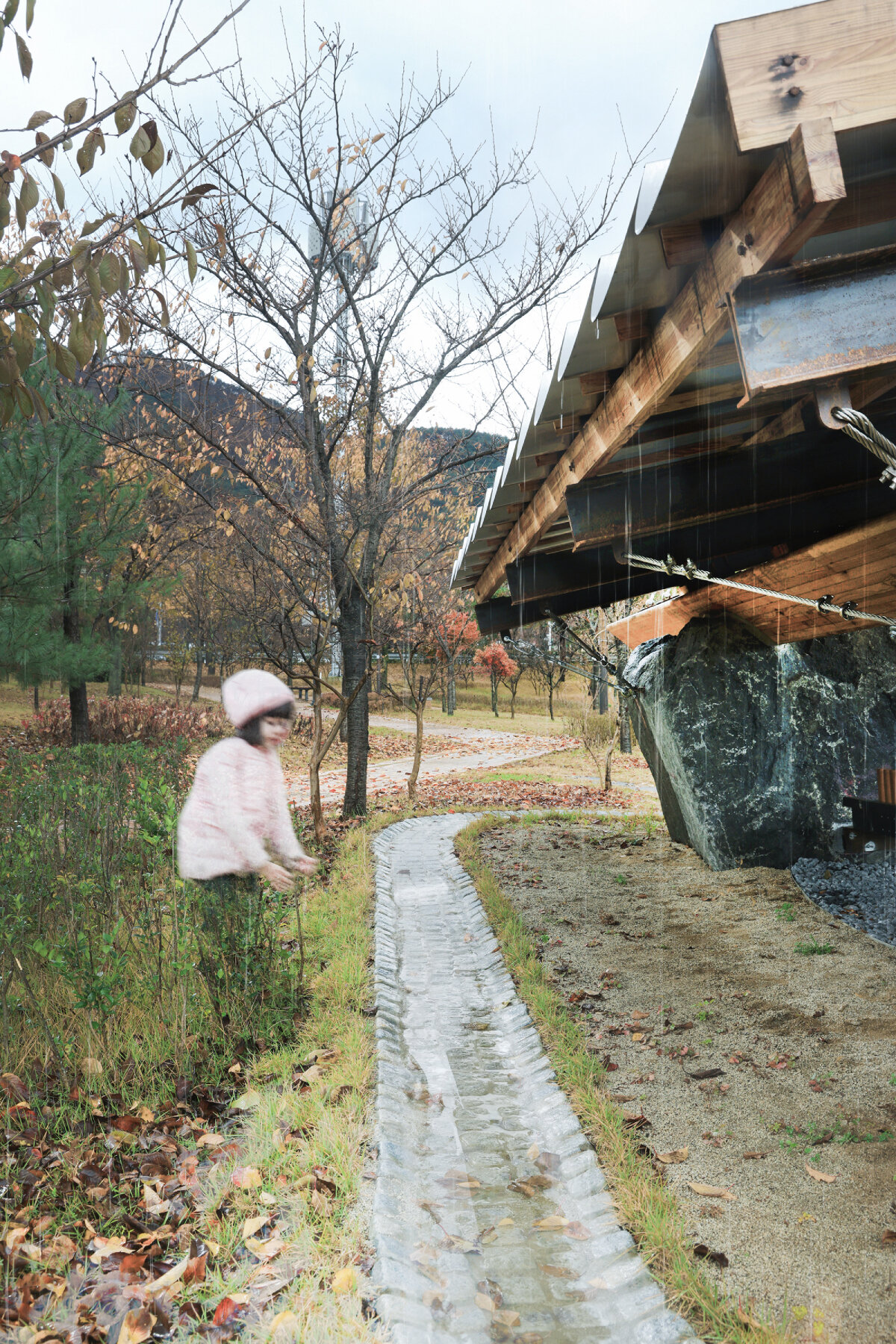 wood & metal canopy rests atop rocks for 'urban interior' installation in south korea
