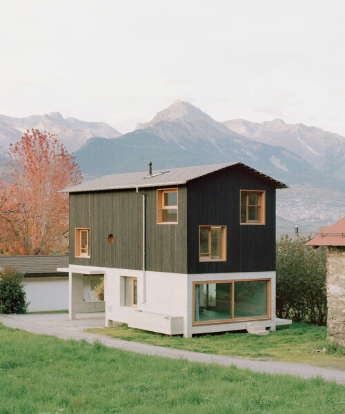 lionel ballmer architectes' charred wood house echoes traditional barns of rural switzerland